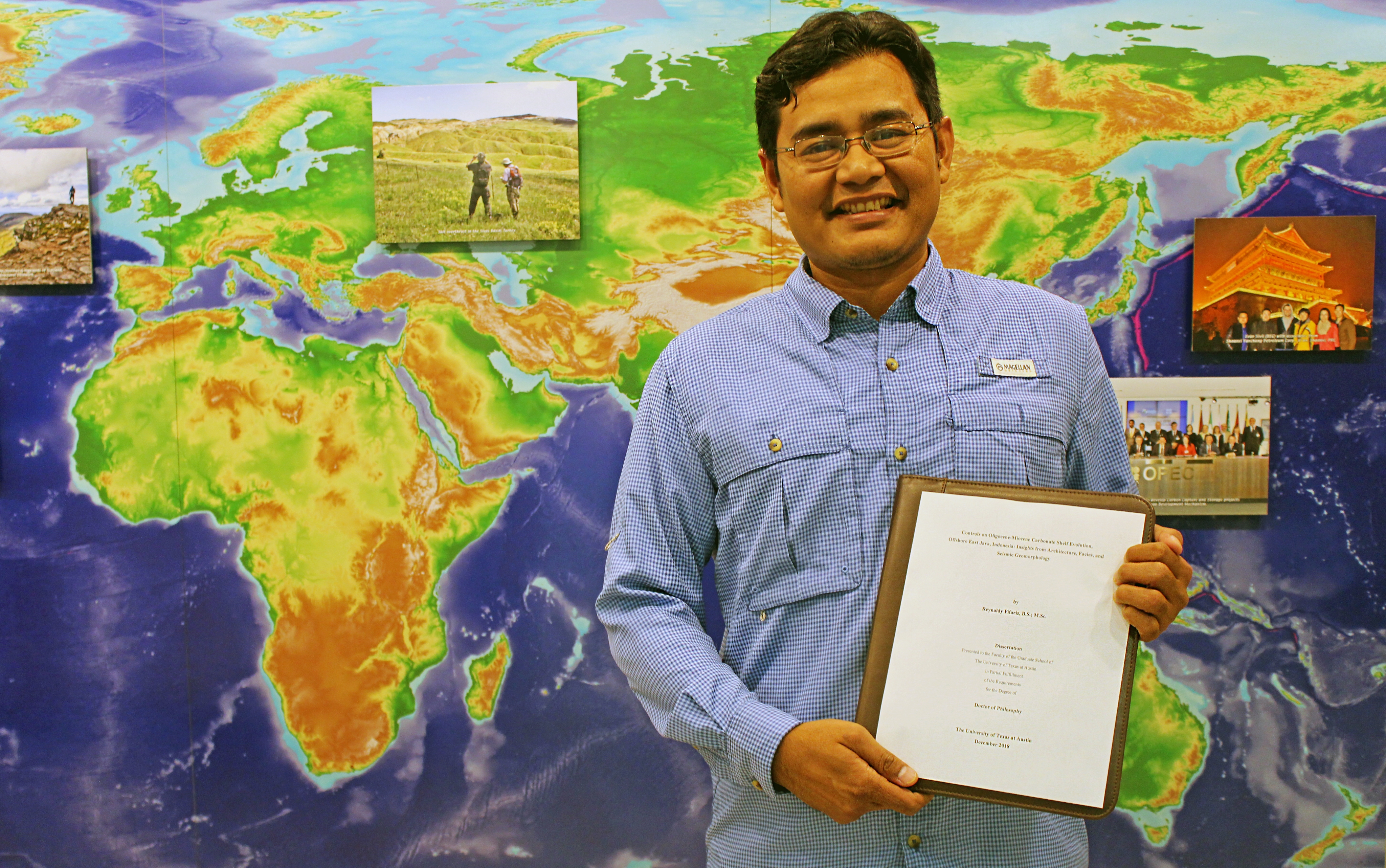 Reynaldy holds his dissertation cover page in front of the Bureau of Economic Geology main hall photo montage