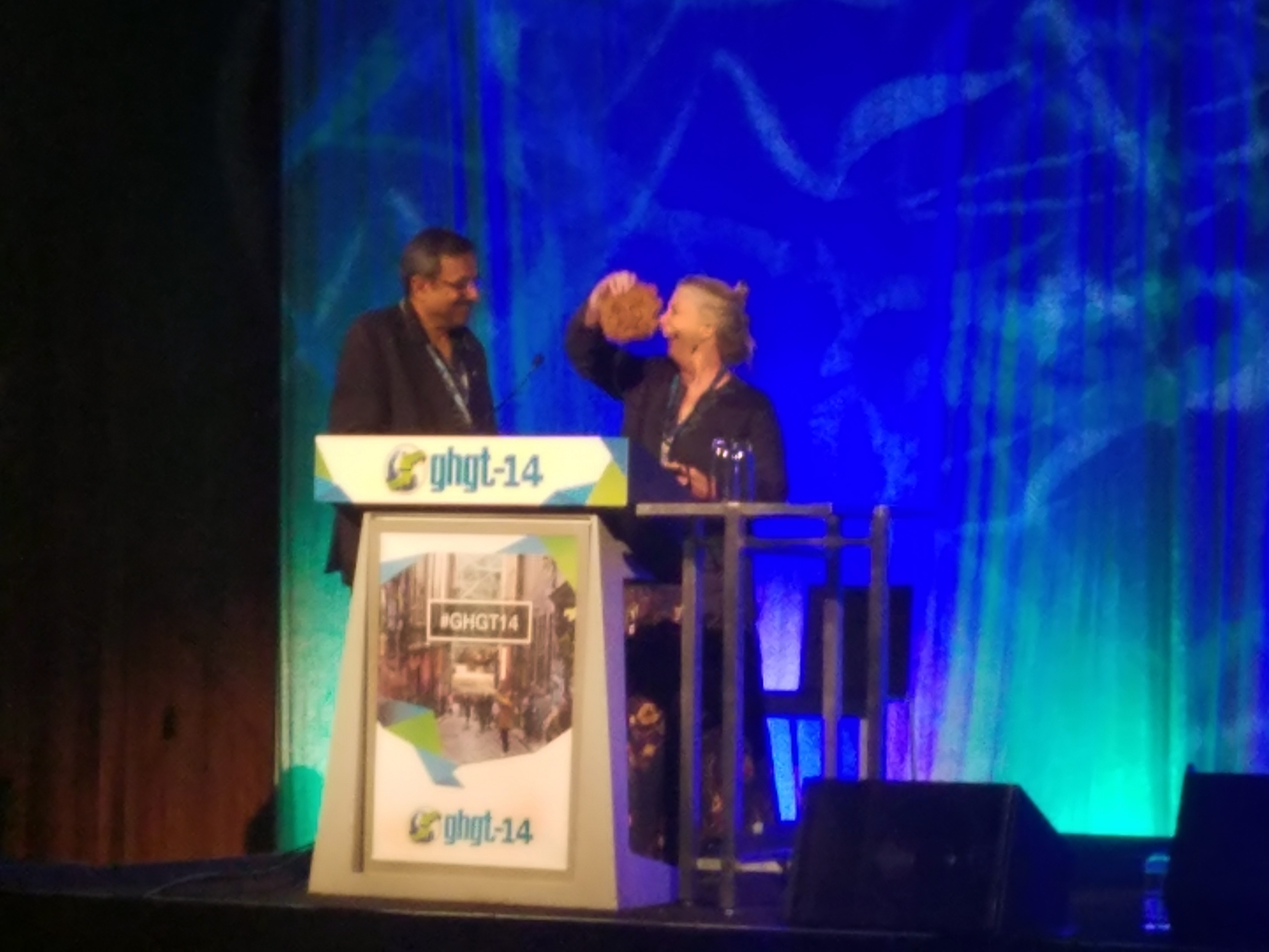 Susan Hovorka is handed the Greenman Award on stage for her contribution to greenhouse gas control technology