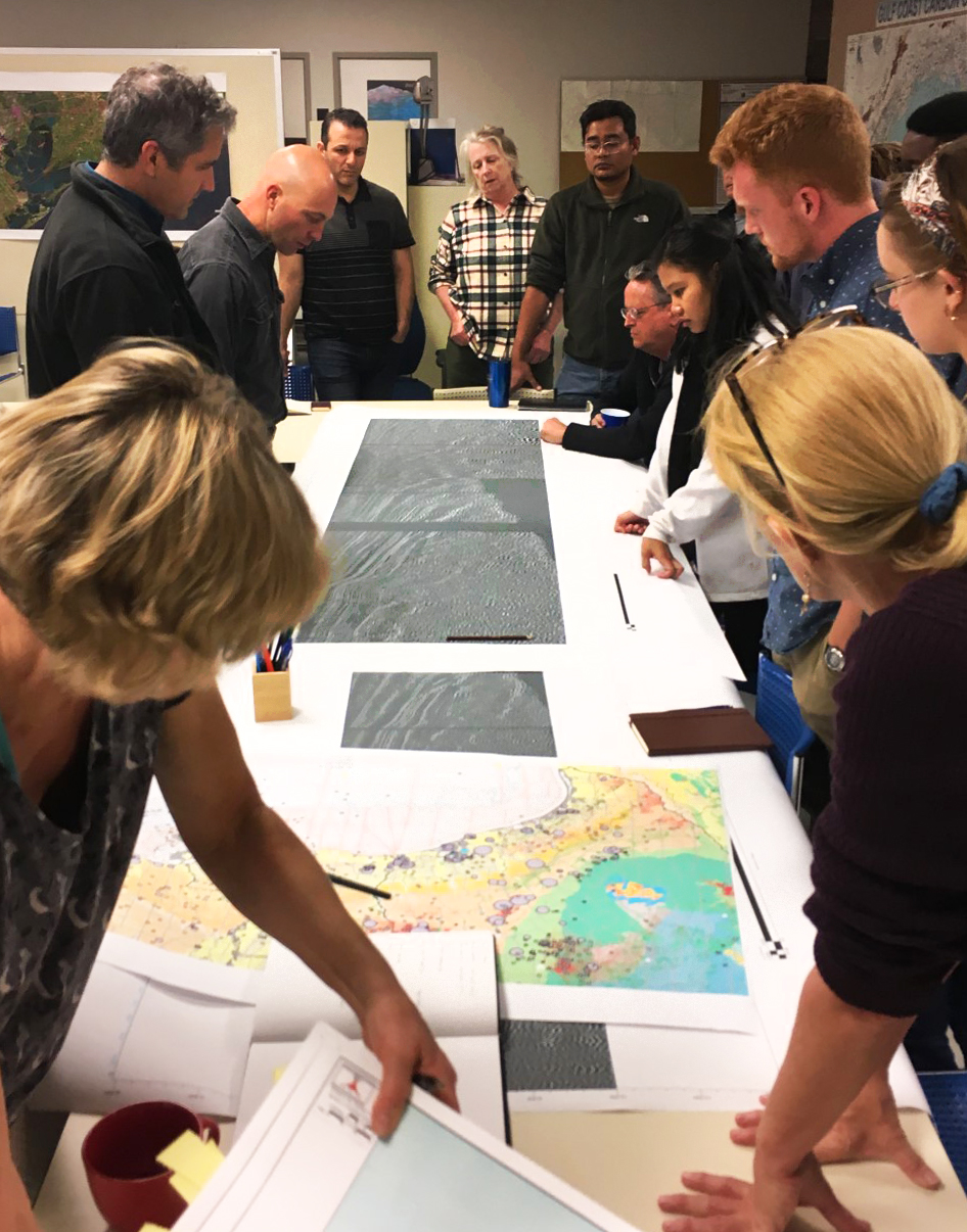 The two research groups gather around the table to examine salt dynamics