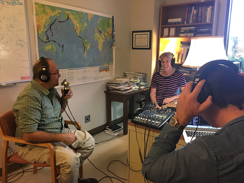 Photo of two podcast hosts interviewing Katherine in her office
