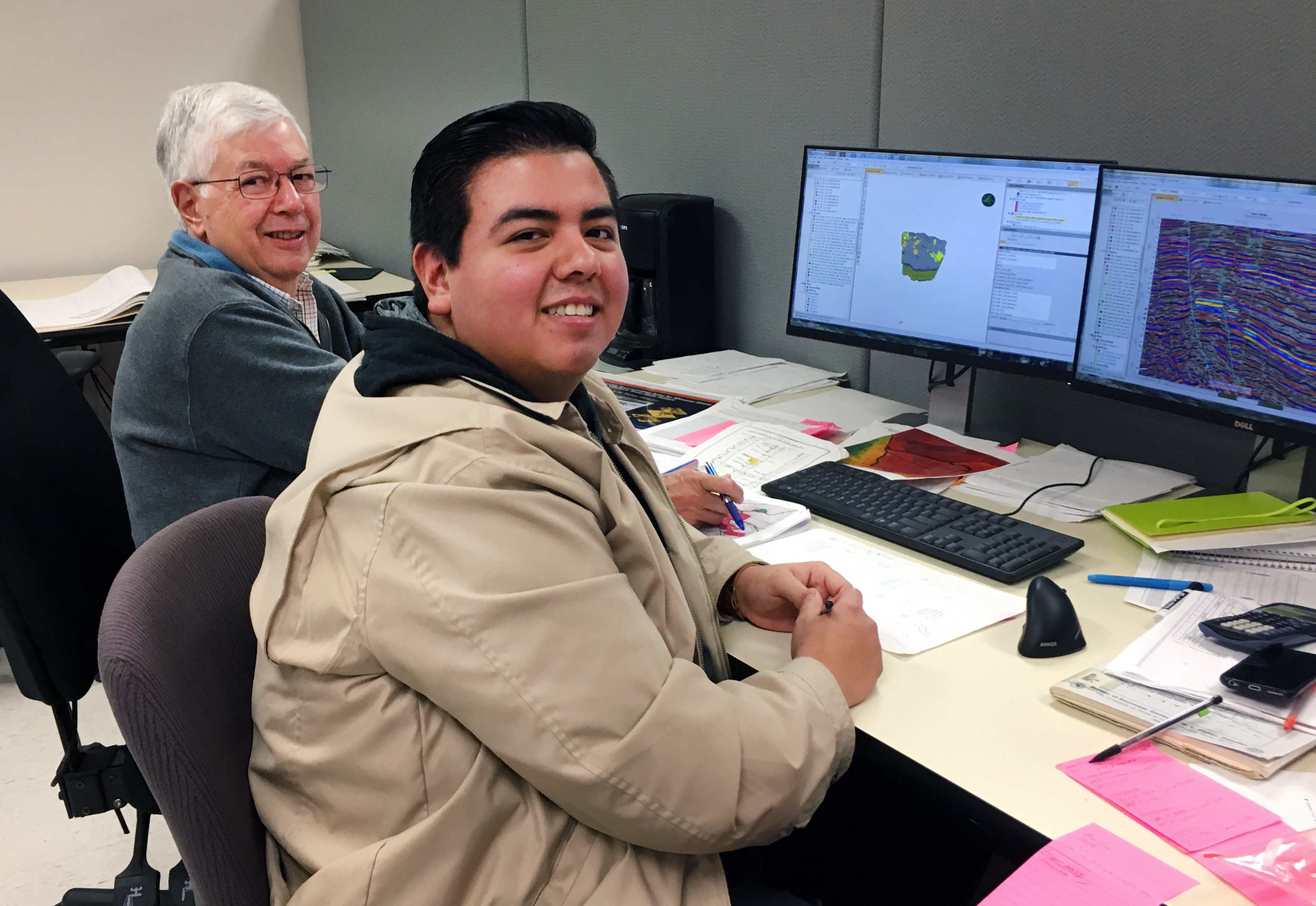 Rob Finley helps Izaak Ruiz troubleshoot subsurface modeling at the computer.