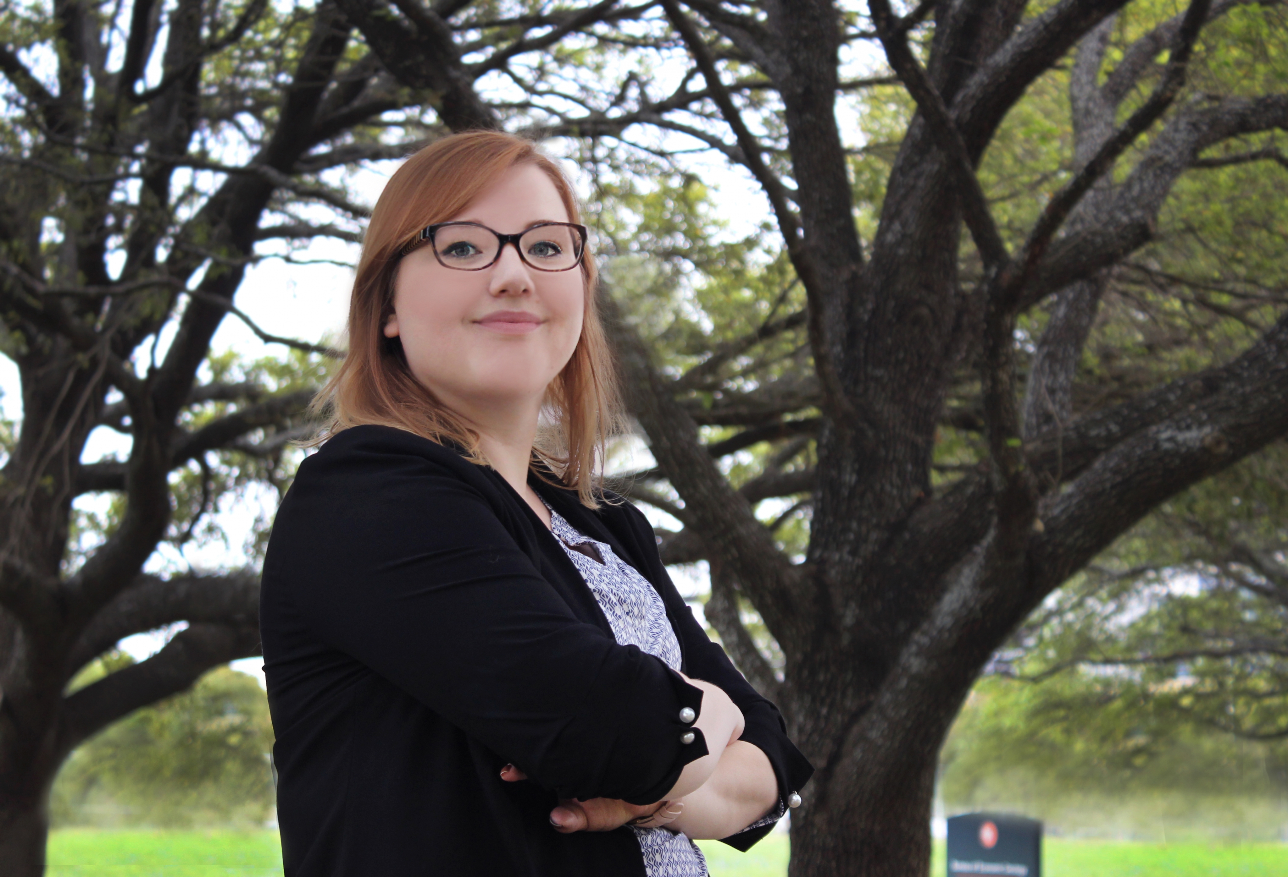 Sarah Prentice stands in front of the Bureau of Economic Geology building at the J. J. Pickle Research Campus.