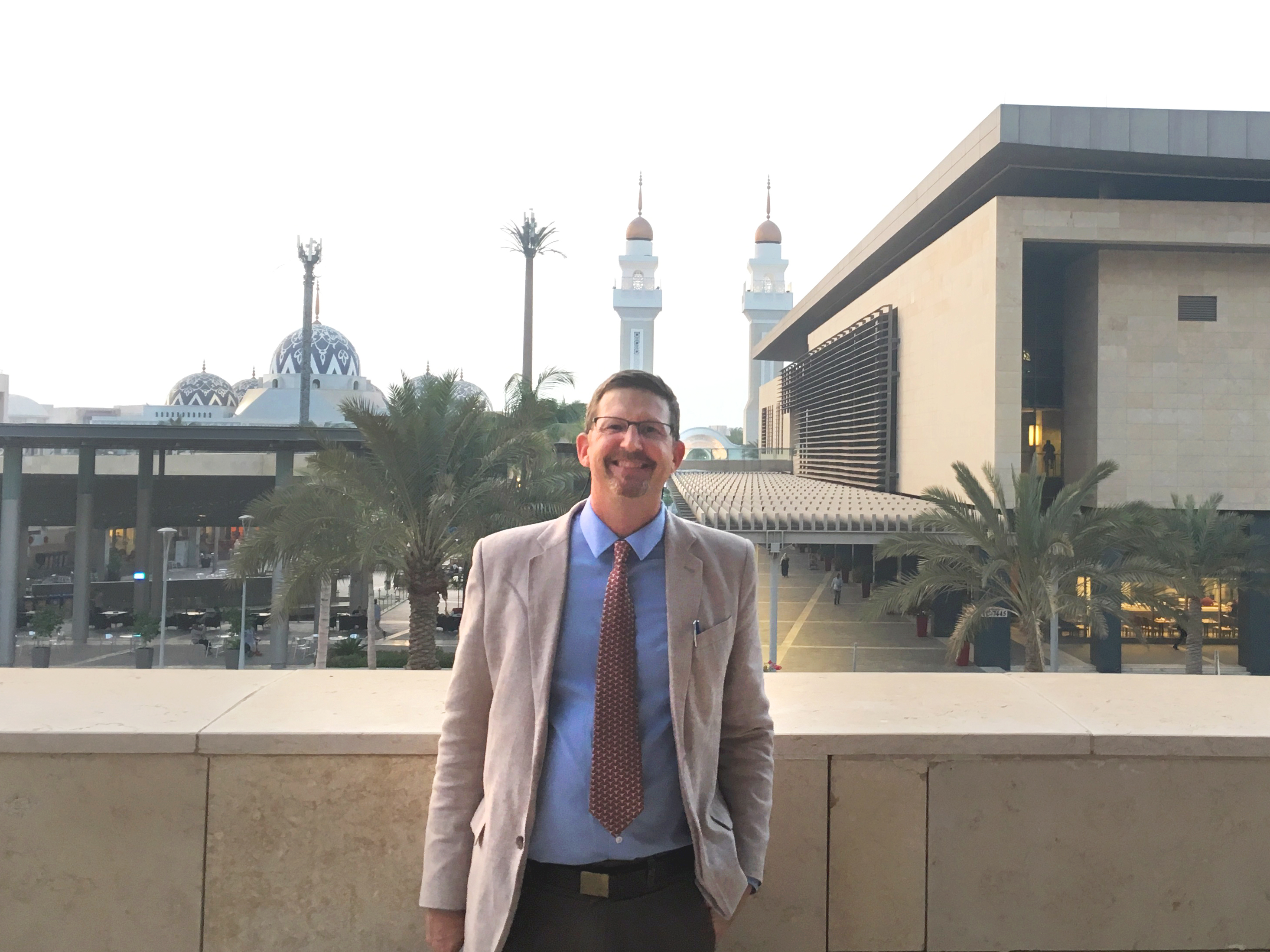 Meckel stands on a balcony overlooking the university's impressive architecture