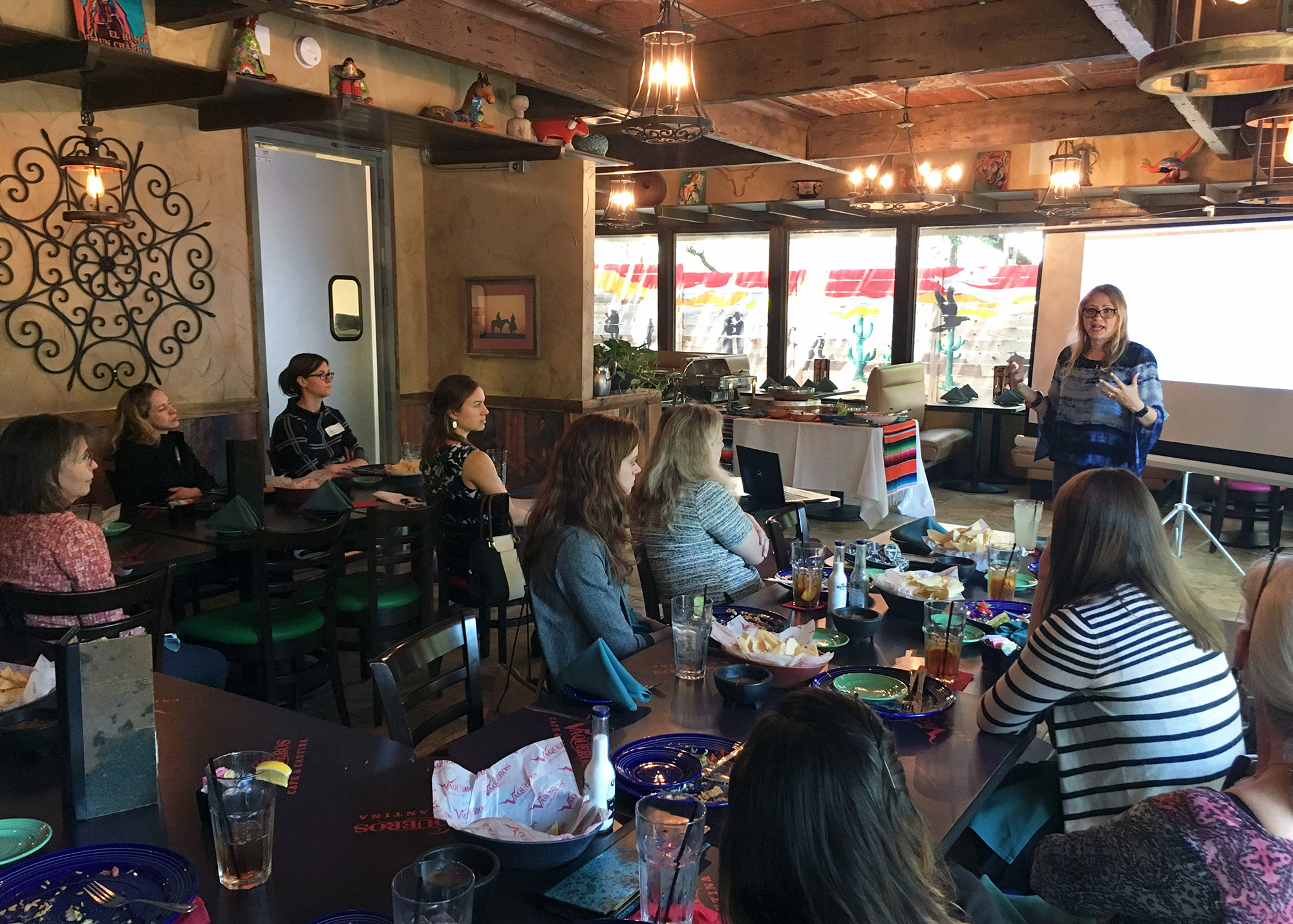 Photo of Vanessa speaking in front of an audience during the annual lunch meeting of Austin WOG