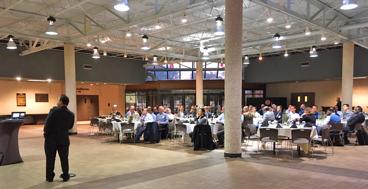 Photo of the attendees in the Commons Center atrium at the JJ PIckle Research Campus at dinner tables during the talk