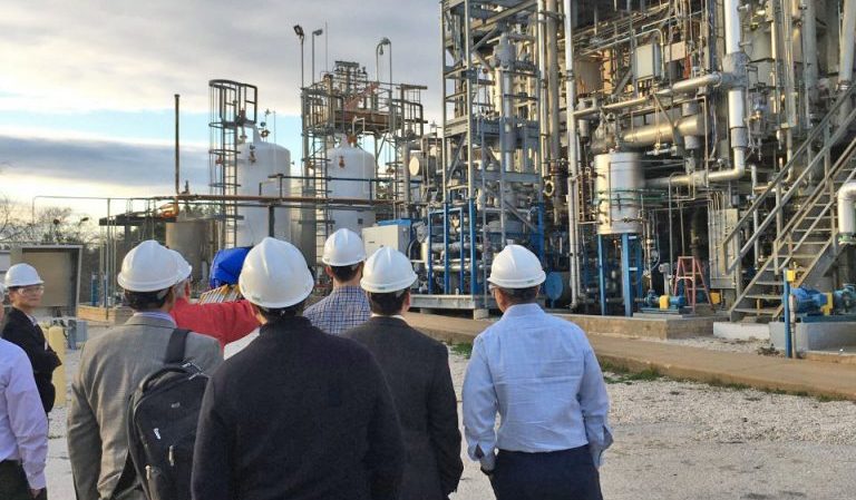 image of a group of people wearing hard hats in front of carbon capture unit